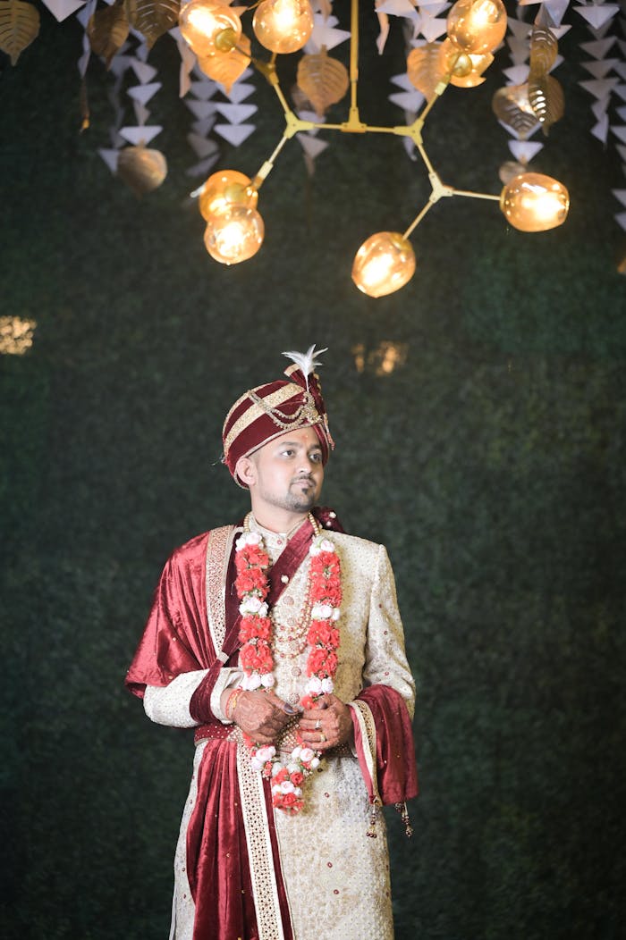 A groom in traditional Indian attire at an elegant wedding ceremony.