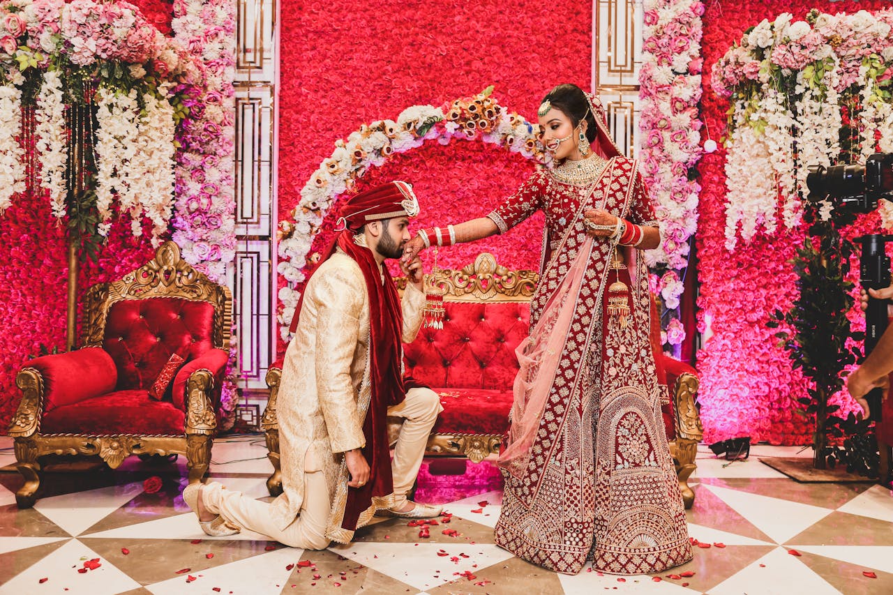 Beautiful Indian bride and groom during elegant traditional wedding ceremony with floral decorations.